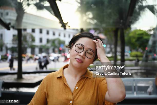 portrait of a chinese woman after work in the business district - chinese indonesians stock pictures, royalty-free photos & images