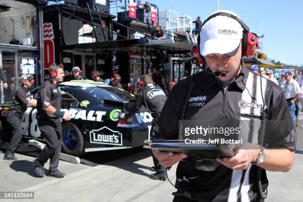 Chad Knaus , crew chief of the Lowe's/Kobalt Tools Chevrolet, driven by Jimmie Johnson, helps prepare a back-up car after Johnson crashed during...