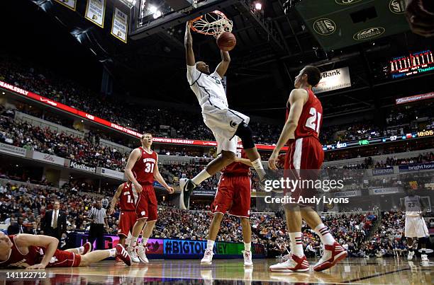 Adreian Payne of the Michigan State Spartans dunks against Josh Gasser of the Wisconsin Badgers during their Semifinal game of the 2012 Big Ten Men's...