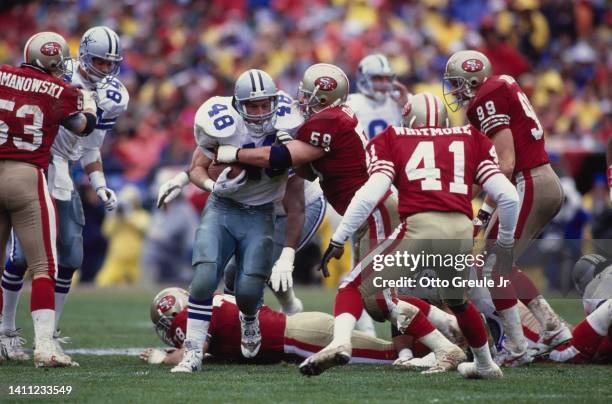 Daryl Johnston, Running Back for the Dallas Cowboys carries the football through the against the San Francisco 49ers defensive line during the...
