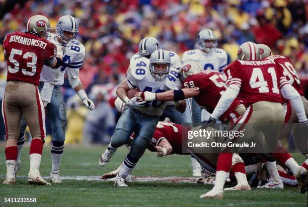 Daryl Johnston, Running Back for the Dallas Cowboys carries the football through the against the San Francisco 49ers defensive line during the...