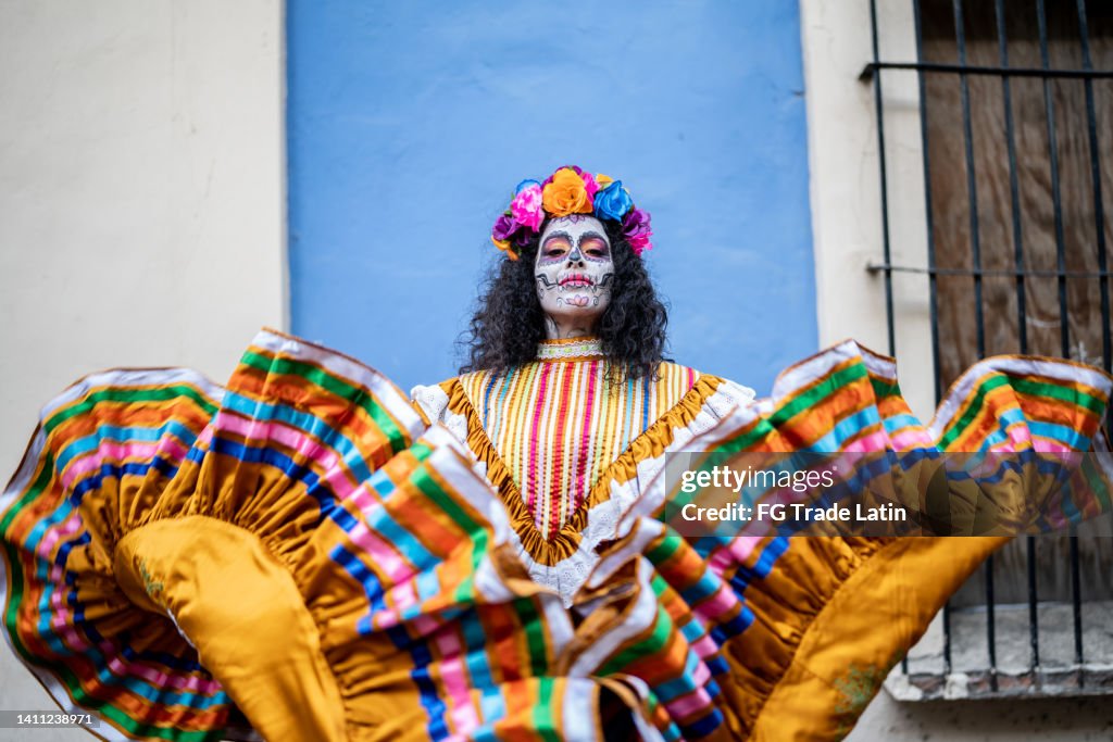 Portrait of a mid adult woman dancing and celebrating the day of the dead