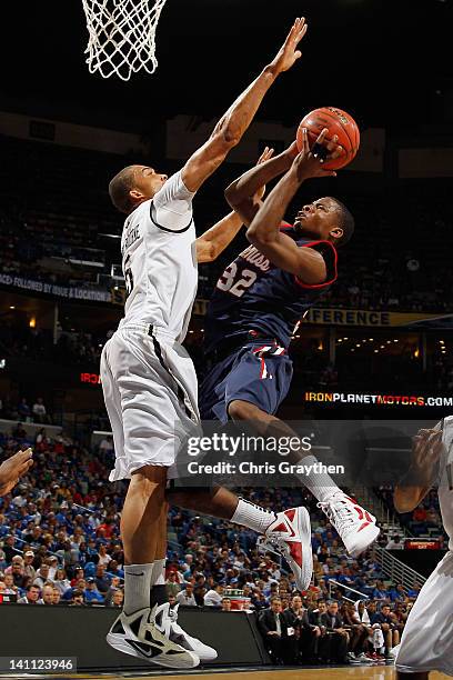 Jarvis Summers of the Mississippi Rebels shoots the ball over Lance Goulbourne of the Vanderbilt Commodores during the Semifinal round of the SEC...