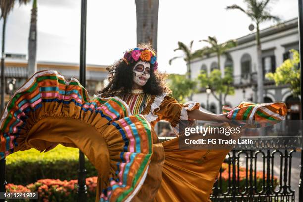 mid adult woman dancing and celebrating the day of the dead - day of the dead stock pictures, royalty-free photos & images