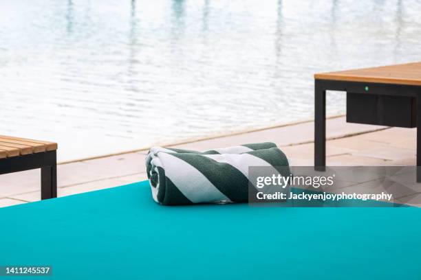 towels on sun loungers by the pool - luxury pool towels stock pictures, royalty-free photos & images