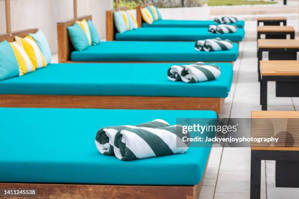 towels on sun loungers by the pool - rolled beach towel stock pictures, royalty-free photos & images