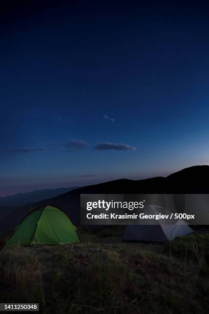 scenic view of tents on field against sky at night - krasimir georgiev stock pictures, royalty-free photos & images