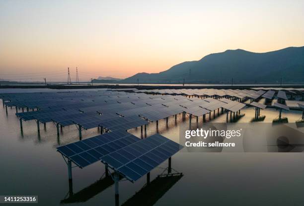 romantic sky in the morning, solar power plant in the sea - green economy foto e immagini stock