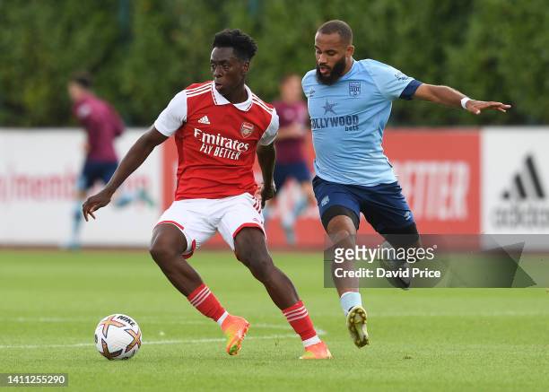 Albert Sambi Lokonga of Arsenal takes on Bryan Mbeumo of Brentford during the pre season friendly between Arsenal and Brentford at London Colney on...