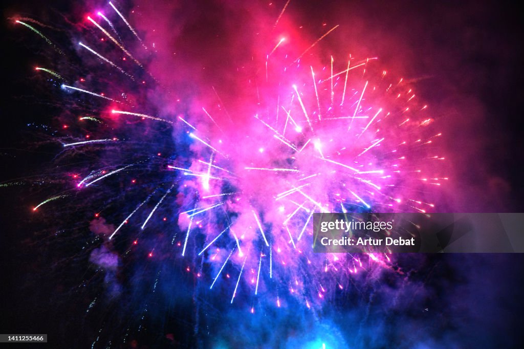 Colorful bright fireworks in the sky during summer festivity in Spain.
