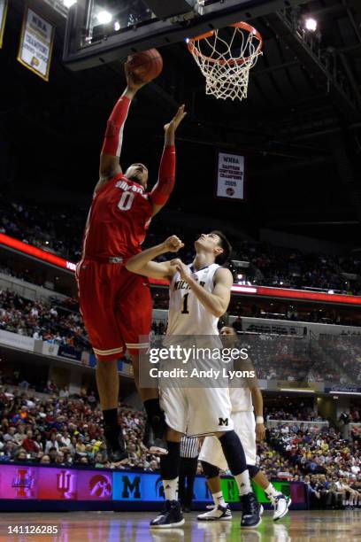 Jared Sullinger of the Ohio State Buckeyes attempts a shot against Stu Douglass of the Michigan Wolverines during their Semifinal game of the 2012...