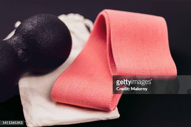 resistance band and blackroll on black background. - blackroll stock pictures, royalty-free photos & images
