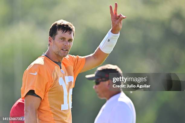 Tom Brady of the Tampa Bay Buccaneers gestures to fans during Buccaneers Training Camp at AdventHealth Training Center on July 27, 2022 in Tampa,...
