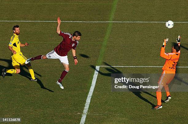 Drew Moor of the Colorado Rapids heads the ball past goalkeeper Andy Gruenebaum of the Columbus Crew after beating Eddie Gaven of the Columbus Crew...