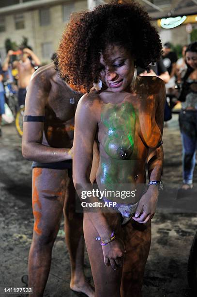 Woman has her bodie painted during the 5th Pedalada Pelada, a naked bike ride to protest against cars, gas emissions and agressive drivers, on March...