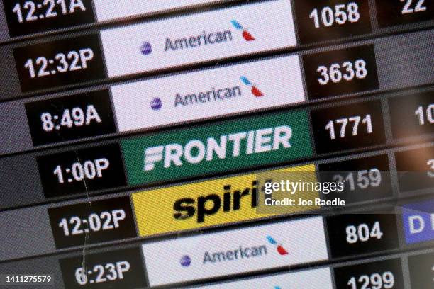 Flight information for a Spirit airlines flight is displayed on the information board at the Miami International Airport on July 27, 2022 in Miami,...