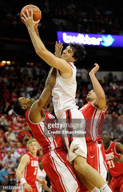 Garrett Green of the San Diego State Aztecs is fouled by A.J. Hardeman of the New Mexico Lobos during the championship game of the Conoco Mountain...