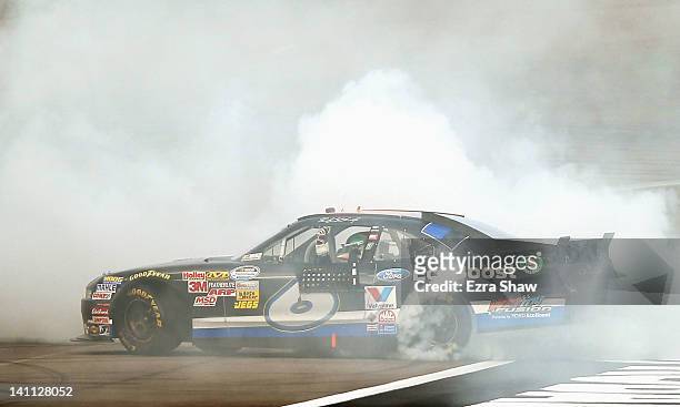 Ricky Stenhouse Jr., driver of the Ford EcoBoost Ford, does a burnout after winning the NASCAR Nationwide Series Sam's Town 300 at Las Vegas Motor...