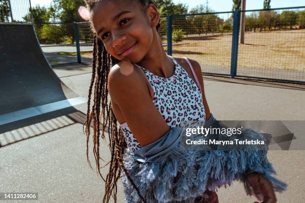 a dark-skinned teenage girl spends time outside. rest. pastime. lifestyle. skate park. - route 13 stock pictures, royalty-free photos & images