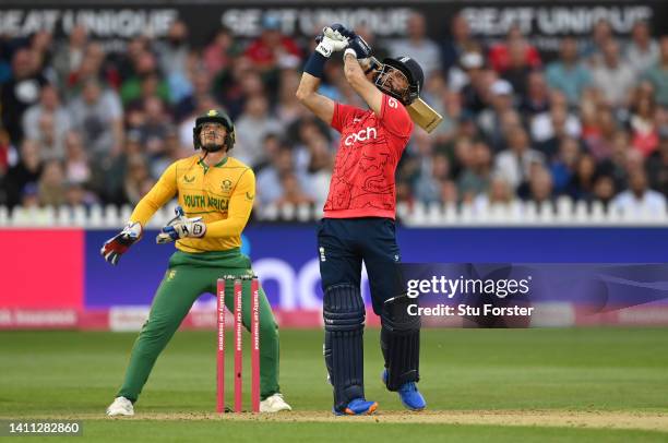 England batsman Moeen Ali hits a six watched by Quinton de Kock during the 1st Vitality IT20 match between England and South Africa at Seat Unique...