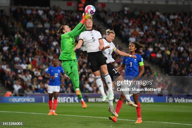 Pauline Peyraud-Magnin of France contends for the aerial ball with Marina Hegering of Germany during the UEFA Women's Euro 2022 Semi Final match...