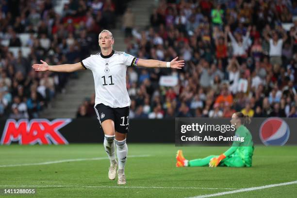 Alexandra Popp of Germany celebrates after scoring their side's first goal as Pauline Peyraud-Magnin of France looks dejected during the UEFA Women's...