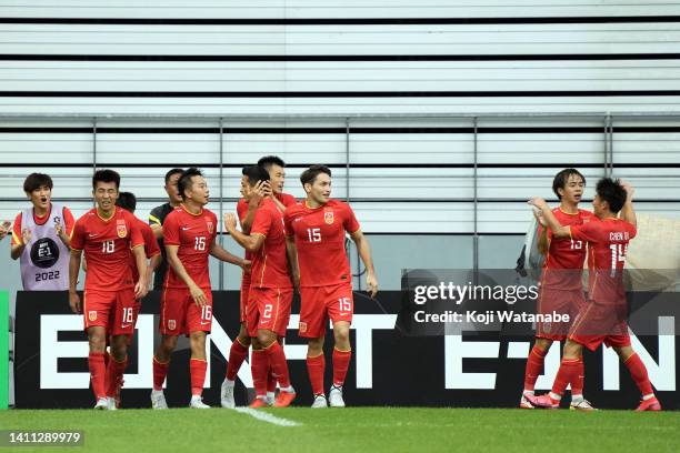 Tan Lon of China celebrates scoring his side's first goal with teammate during the EAFF E-1 Football Championship match between China and Hong Kong...