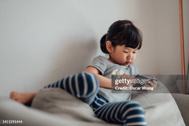 child using a smart phone - mobile game stock pictures, royalty-free photos & images