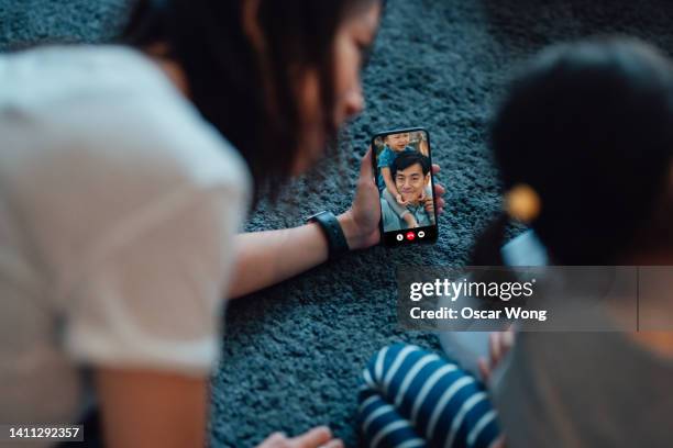 family on video call with smart phone - photo messaging stock pictures, royalty-free photos & images