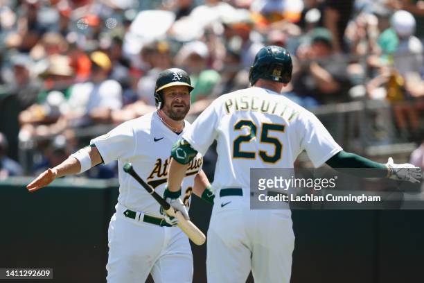 Stephen Vogt of the Oakland Athletics celebrates with Stephen Piscotty after hitting a solo home run in the bottom of the second inning against the...