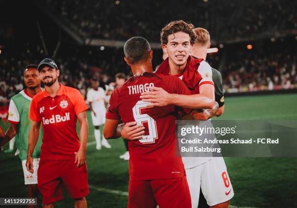 Dijon Kameri of Salzburg is hugged by Thiago Alcantara of Liverpool after the friendly match between FC Red Bull Salzburg and Liverpool FC at Red...