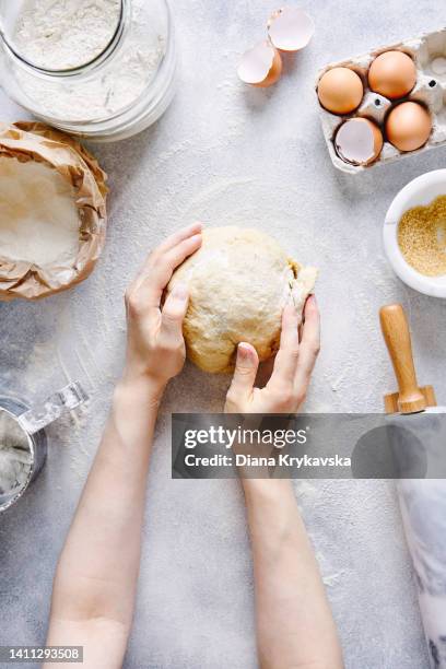 young woman kneading dough. making yeast dough. - sifting stock photos et images de collection