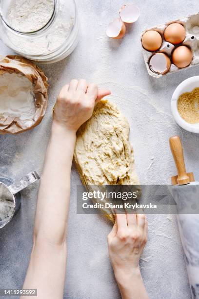 young woman kneading dough. making yeast dough. - kneading stock pictures, royalty-free photos & images