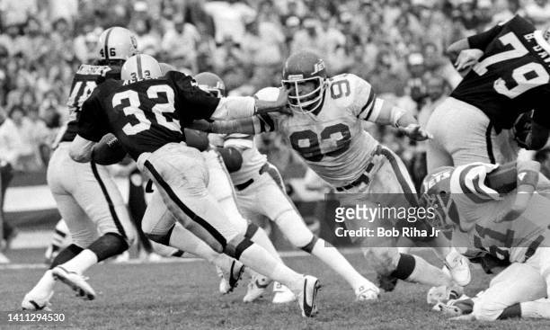 Raiders RB Marcus Allen straight arms NY Jets DT Marty Lyons during AFC Playoff game, January 15, 1983 in Los Angeles, California.