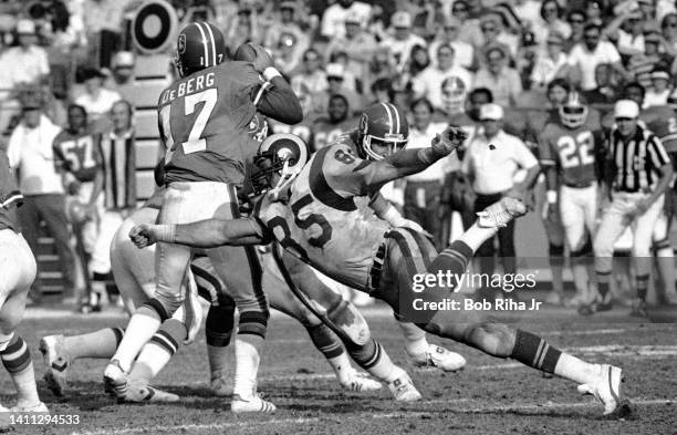 Denver Broncos QB Steve DeBerg under heavy pressure by Los Angeles Rams DE Jack Youngblood during game, December 12, 1982 in Anaheim, California.