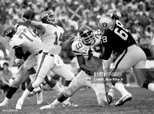 Jets QB Richard Todd under heavy pressure from Raiders Marvin Powell during AFC Playoff game, January 15, 1983 in Los Angeles, California.