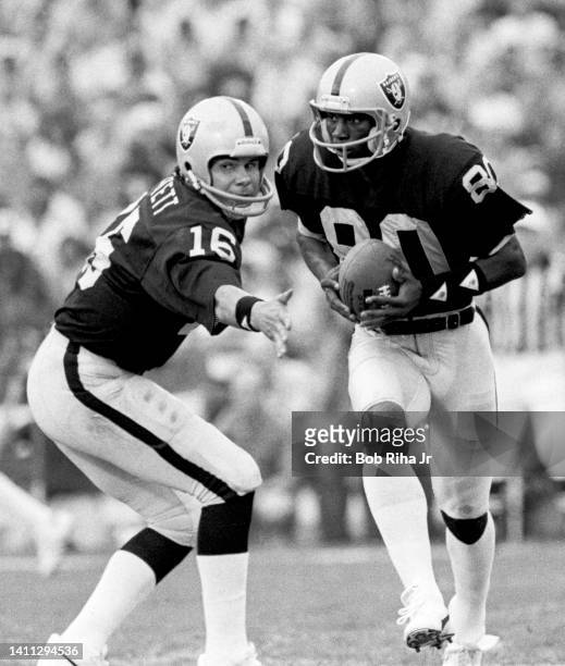Raiders QB Jim Plunkett hands ball off to WR Malcolm Barnwell during AFC Playoff game, January 15, 1983 in Los Angeles, California.