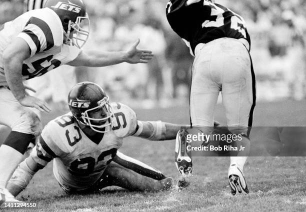 Raiders RB Marcus Allen powers through outstretched arms of NY Jets Joe Klecko on run play during AFC Playoff game, January 15, 1983 in Los Angeles,...