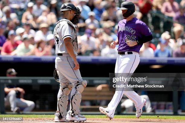 Cron of the Colorado Rockies scores on a Jose Iglesias RBI double against the Chicago White Sox in the first inning at Coors Field on July 27, 2022...