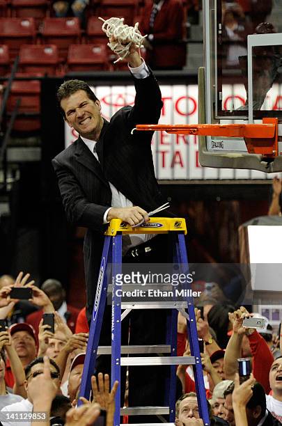 Head coach Steve Alford of the New Mexico Lobos cuts down the net after defeating the San Diego State Aztecs 68-59 to win the championship game of...