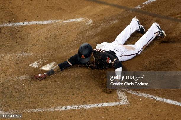 Sergio Alcantara of the Arizona Diamondbacks scores a run during the seventh inning against the San Francisco Giants at Chase Field on July 27, 2022...