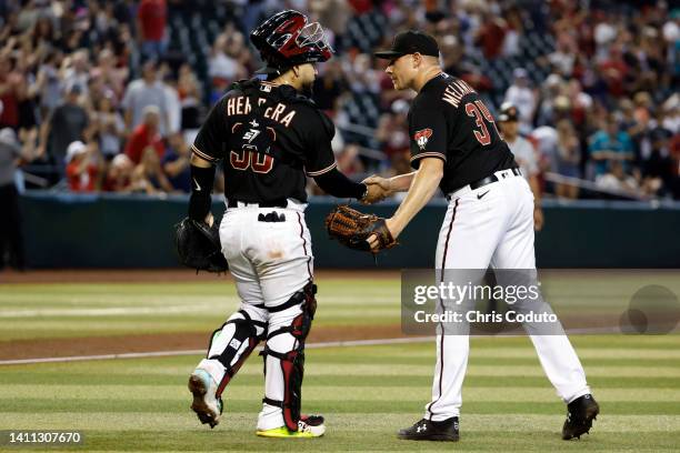 Mark Melancon shakes hands with catcher Jose Herrera of the Arizona Diamondbacks after the Diamondbacks beat the San Francisco Giants 5-3 at Chase...