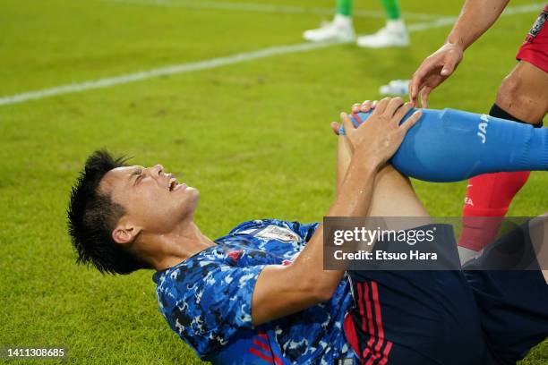 Ryo Miyaichi of Japan lies injured during the EAFF E-1 Football Championship match between Japan and South Korea at Toyota Stadium on July 27, 2022...