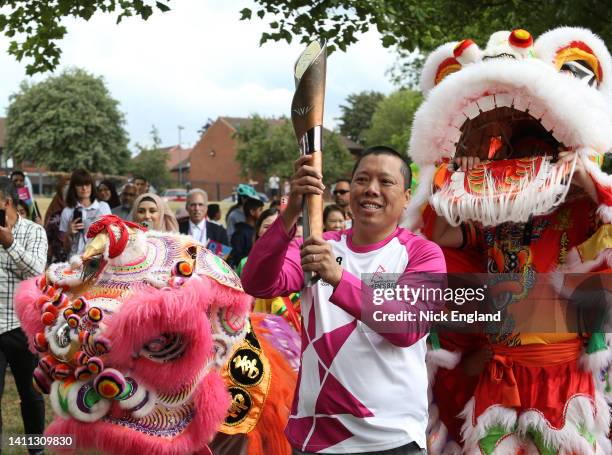 Batonbearer James Wong holds the Queen's Baton during the Birmingham 2022 Queen's Baton Relay on July 27, 2022 in Bordesley, Birmingham, United...