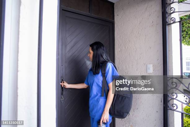 woman nurse leaving home - nurse leaving stock pictures, royalty-free photos & images