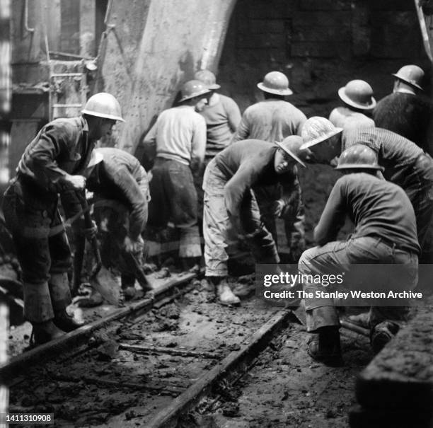 Team of sandhogs clear sediment during the construction of the Lincoln Tunnel's third tube, Weehawken, New Jersey, February 11, 1955. After the...