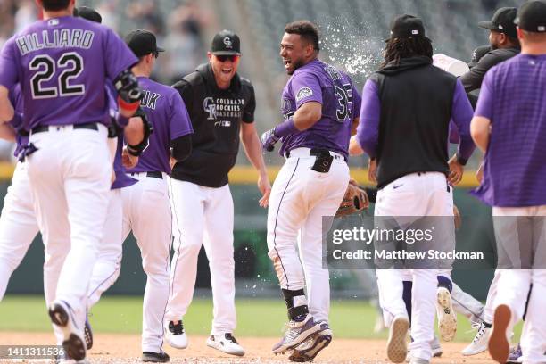 Elias Diaz of the Colorado Rockies celebrates with his teammates after hitting a 2 RBI walk off single against the Chicago White Sox in the ninth...