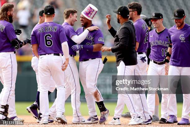 Elias Diaz of the Colorado Rockies celebrates with his teammates after hitting a 2 RBI walk off single against the Chicago White Sox in the ninth...