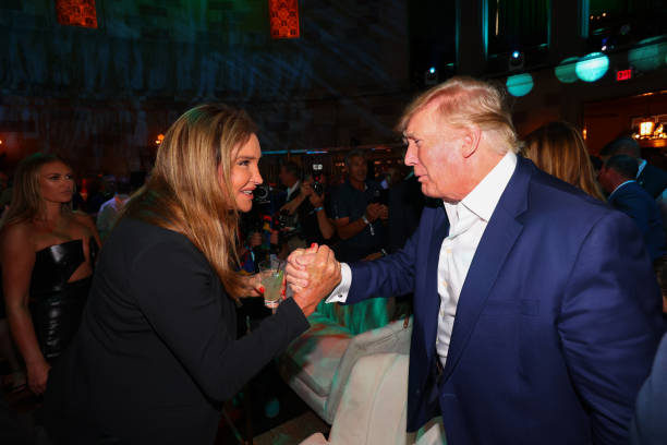 Caitlyn Jenner shakes hands with former U.S. President Donald Trump during the welcome party for the LIV Golf Invitational - Bedminster at Gotham...