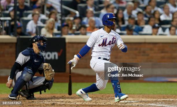 Francisco Lindor of the New York Mets follows through on a third inning RBI single against the New York Yankees at Citi Field on July 27, 2022 in New...